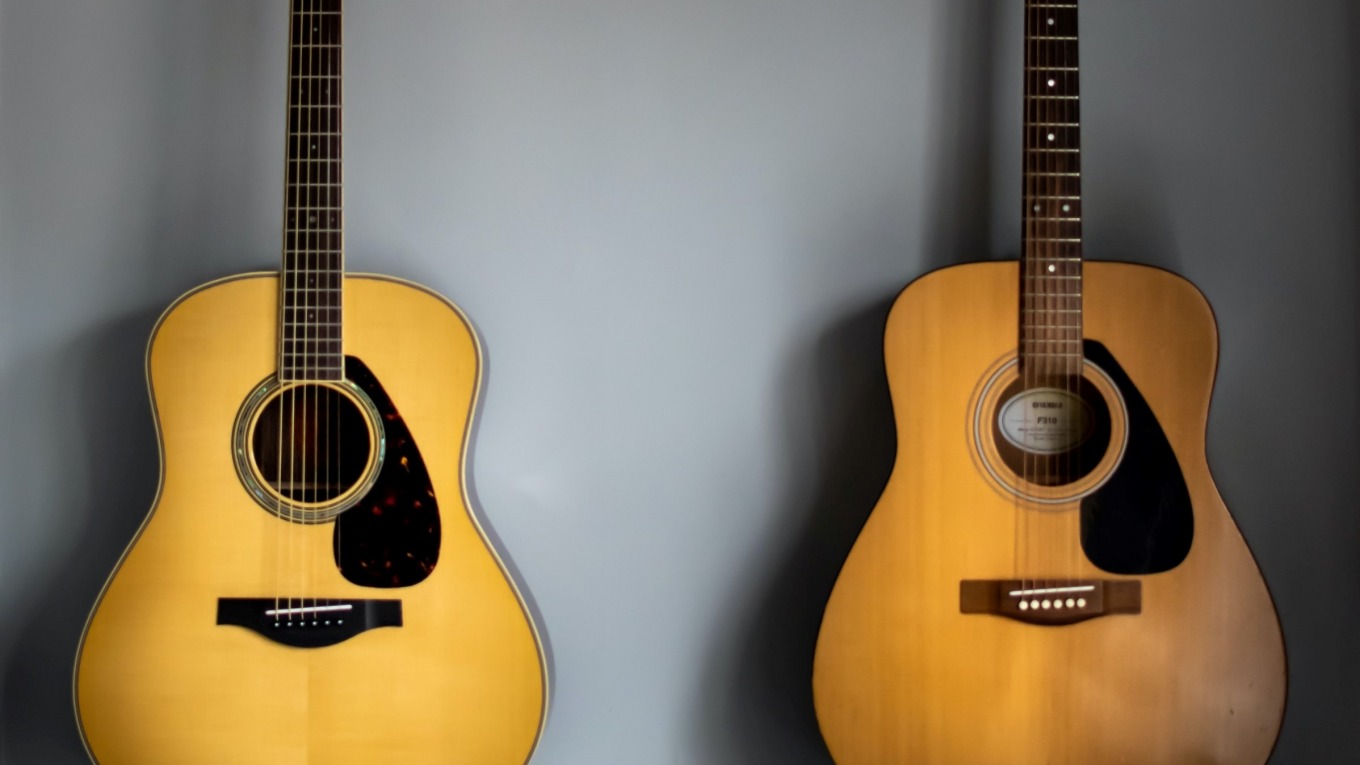 2 guitars hanging on the wall