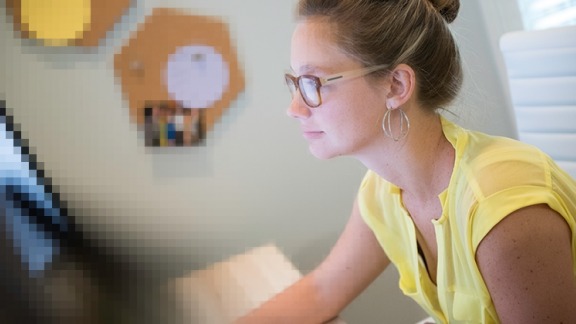 Hannah sitting at her desk working